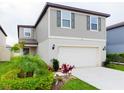 Charming two-story home featuring a two-car garage and beautifully landscaped front yard at 29922 Marquette Ave, Wesley Chapel, FL 33545
