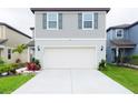 Attractive two-story home with a two-car garage, complemented by a neat lawn at 29922 Marquette Ave, Wesley Chapel, FL 33545