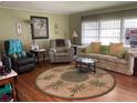 Cozy living room with a tropical-themed rug and comfortable seating arrangement at 3301 Alt 19 # 700, Palm Harbor, FL 34683
