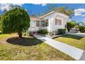 Cozy single-story home with a well-kept lawn and a charming walkway to the entrance at 585 Sky Harbor Dr # 416, Clearwater, FL 33759