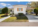 Inviting single-story home featuring a covered parking space and tidy front yard at 585 Sky Harbor Dr # 416, Clearwater, FL 33759