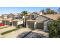 Wide angle exterior showcasing townhouses each with private garages and manicured landscaping at 720 Earls Ct, Safety Harbor, FL 34695