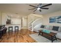 Open concept living room with stairs, wood floors, and bar stool seating at kitchen counter at 720 Earls Ct, Safety Harbor, FL 34695