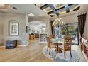 Spacious dining room showcases a modern chandelier, tray ceiling detail and opens to other living areas in the home at 1535 Lake Polo Dr, Odessa, FL 33556