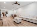 Bright living room with hardwood floors, a ceiling fan, and a comfortable white sofa at 2004 N Grady Ave, Tampa, FL 33607