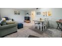 Open living and dining area featuring comfortable seating and carpeted floors at 2042 Australia W Way # 66, Clearwater, FL 33763