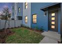Inviting new home exterior features a blue facade, modern door, and manicured lawn at 2209 16Th N St, St Petersburg, FL 33704