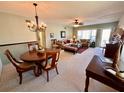 Cozy living and dining area features carpeted floors, neutral paint, and views from the covered porch at 2351 Irish Ln # 43, Clearwater, FL 33763