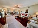 Open-concept living and dining area boasts carpeted floors and a ceiling fan at 2351 Irish Ln # 43, Clearwater, FL 33763