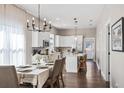 Open kitchen and dining area featuring stainless steel appliances, a center island, and modern finishes at 3002 N 16Th St, Tampa, FL 33605