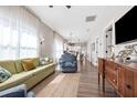Bright living room featuring hardwood floors, a large window, and open access to the kitchen at 3002 N 16Th St, Tampa, FL 33605