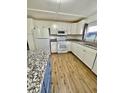 Bright kitchen with granite countertops and modern white appliances at 34344 Timberland Blvd, Wesley Chapel, FL 33543