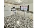 Bright, modern kitchen with white cabinets and stainless appliances at 34344 Timberland Blvd, Wesley Chapel, FL 33543