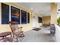 Cozy covered front porch with rocking chair and sitting area at 3908 Alafia Blvd, Brandon, FL 33511