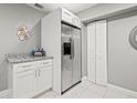 Kitchen area with stainless steel refrigerator and granite counters at 3908 Alafia Blvd, Brandon, FL 33511