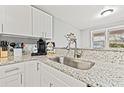 Modern kitchen sink with granite countertops and white cabinets at 3908 Alafia Blvd, Brandon, FL 33511