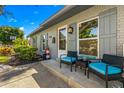 Inviting front porch with seating, decorative lighthouse, and charming details on a well-maintained gray brick home at 4135 Beach Se Dr, St Petersburg, FL 33705