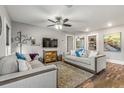 Spacious living room with hardwood floors, comfortable seating, ceiling fan, and stylish decor for a cozy atmosphere at 4135 Beach Se Dr, St Petersburg, FL 33705