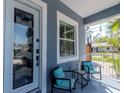 Welcoming front porch with stylish seating, a decorative window, and a beautiful stained-glass door at 5526 14Th S Ave, Gulfport, FL 33707