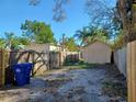 View of the spacious backyard featuring a wooden fence and detached garage at 711 Smith St, Clearwater, FL 33756