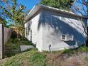 Exterior view of a shed featuring a door, window AC unit, and a vent at 711 Smith St, Clearwater, FL 33756