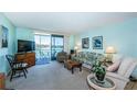 Cozy living room with access to a screened balcony offering views of the waterfront at 7405 Bay Island S Dr # 220, South Pasadena, FL 33707