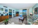Inviting living room with sliding glass doors leading to a balcony overlooking the water at 7405 Bay Island S Dr # 220, South Pasadena, FL 33707