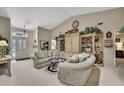 Bright living room showcasing vaulted ceiling, dual sofas, and an elegant entrance at 7435 Woodhollow Rd, Spring Hill, FL 34606