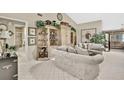 Inviting living room with neutral tones, decorative shelves, and cozy seating at 7435 Woodhollow Rd, Spring Hill, FL 34606