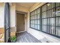 Inviting front entryway featuring a tiled porch, large windows, and a secure door at 7703 Rockville Ct # 0, New Port Richey, FL 34654