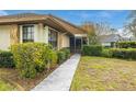 Home exterior featuring a charming walkway, stone accents, and a screened entryway at 7703 Rockville Ct # 0, New Port Richey, FL 34654