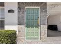 The home has a beautiful light green front door with stone accents and a covered carport for convenience at 7825 38Th N Ter # 7825, St Petersburg, FL 33709