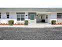 Charming single-story home with a light green front door, decorative stone accents, and a convenient attached carport at 7825 38Th N Ter # 7825, St Petersburg, FL 33709