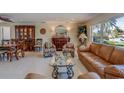 Spacious living room featuring a decorative cabinet, a sofa and chairs, and ample natural light at 809 Royal Dr, Largo, FL 33770