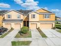 Inviting townhome exterior showcasing attached garages and well-maintained landscaping in a desirable neighborhood at 8842 Turnstone Haven Pl, Tampa, FL 33619