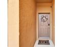 Charming front entrance with a decorative wreath, welcome mat, and beige door at 8842 Turnstone Haven Pl, Tampa, FL 33619