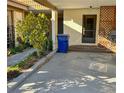 Carport view with a blue trashcan placed near the unit at 9221 Repondo Pl, New Port Richey, FL 34655