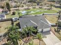 Expansive backyard view of a private screened-in pool, pond, and white vinyl fence at 9705 Mary Robin Dr, Riverview, FL 33569