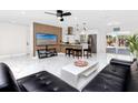 Bright living area with open floorplan, a stylish TV display and island seating adjacent to the kitchen at 1100 Webb Dr, Clearwater, FL 33755