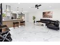 Bright, open living area features an island with barstool seating and access to kitchen and backyard at 1100 Webb Dr, Clearwater, FL 33755