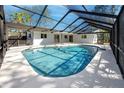 A refreshing screened-in pool features a spacious deck and clear blue water, perfect for outdoor relaxation at 1100 Webb Dr, Clearwater, FL 33755