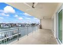 Condo balcony offers scenic views of the river, white railings, and two ceiling fans at 125 Island Way # 404, Clearwater Beach, FL 33767
