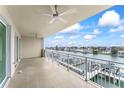 Spacious condo balcony features views of the river, a white railing, and two ceiling fans at 125 Island Way # 404, Clearwater Beach, FL 33767