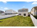 Spacious backyard with lush green grass and a white vinyl fence, perfect for outdoor activities at 12846 Tannencrest Dr, Riverview, FL 33579
