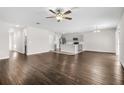 Open-concept living room with modern wood flooring, neutral paint and abundant natural light at 12846 Tannencrest Dr, Riverview, FL 33579