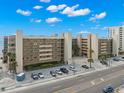 Exterior view of the beautiful condo building with well-maintained landscaping at 14900 Gulf Blvd # 304, Madeira Beach, FL 33708