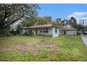 Exterior shot of single-story home including a detached garage/workshop at 1920 E Clifton St, Tampa, FL 33610