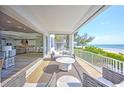 Inviting outdoor balcony showcases comfortable seating and stunning ocean views at 20256 Gulf Blvd, Indian Shores, FL 33785