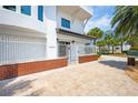 Charming home with a gated entrance and a well-manicured brick and paver walkway at 20256 Gulf Blvd, Indian Shores, FL 33785