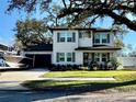 Charming two-story home with a well-manicured front lawn, boat, and convenient attached garage at 3012 W Leroy St, Tampa, FL 33607